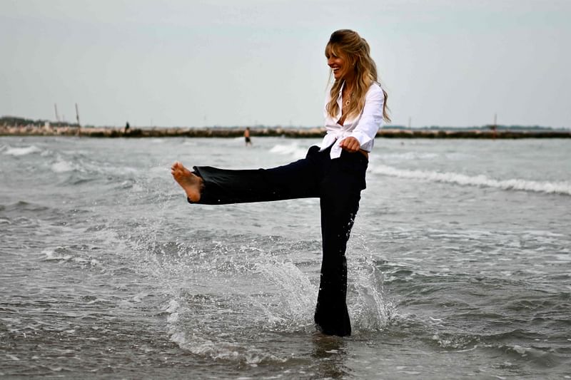 Actress Sveva Alviti, patroness of the 81st Venice International Film Festival, poses for photographers on 27 August 2024 during a photo call on the beach of the Excelsior Hotel at Lido di Venezia in Venice, Italy, on the eve of the festival’s opening